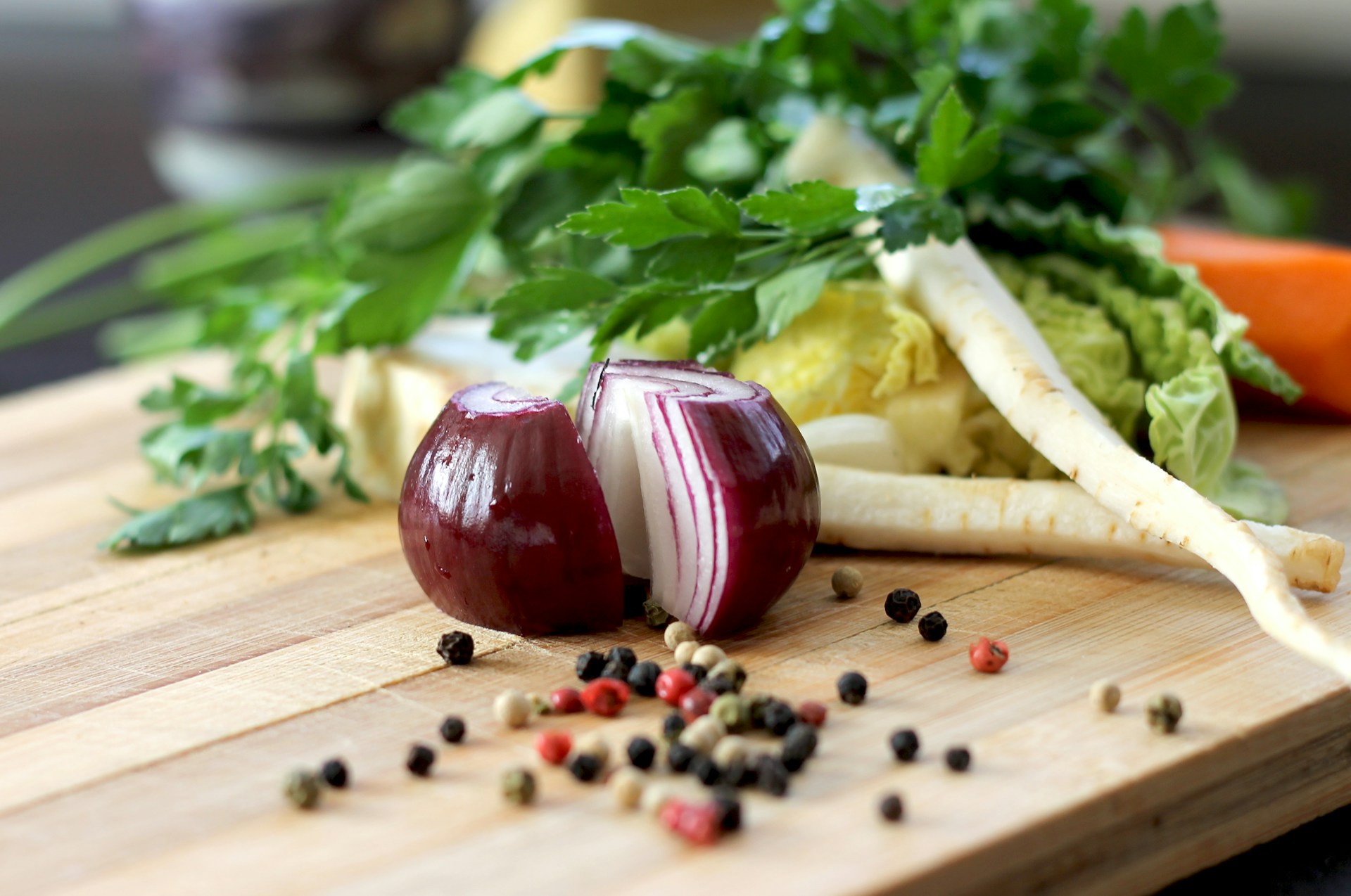 Naturopathic Training. Photo of onion, carrots, and other whole foods on a cutting board.